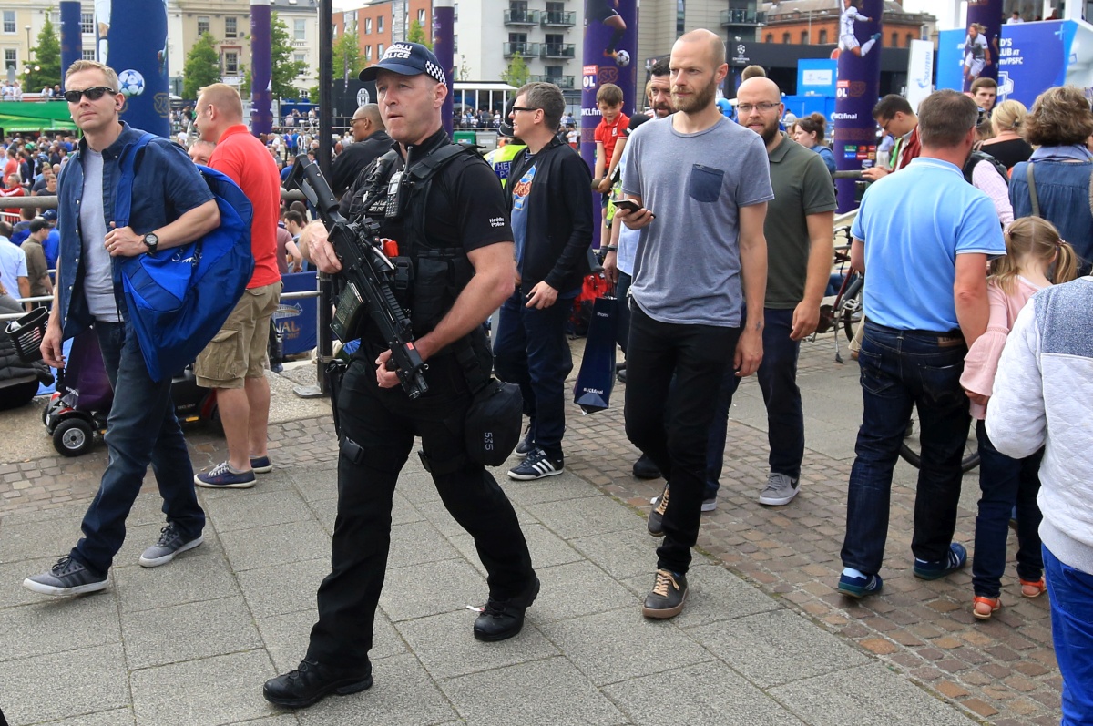 CARDIFF, WALES - JUNE 02: Armed police officers with guns patrol the Champions Festival prior to the UEFA Champions League Final between Juventus and Real Madrid on June 02, 2017 in Cardiff, Wales. (Photo by Catherine Ivill - AMA/Getty Images)
